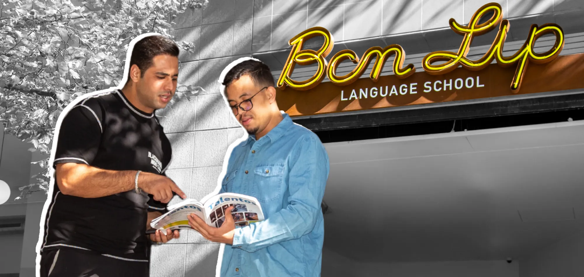 Two students studying together outside BCN Lip Language School, with the school sign visible in the background.
